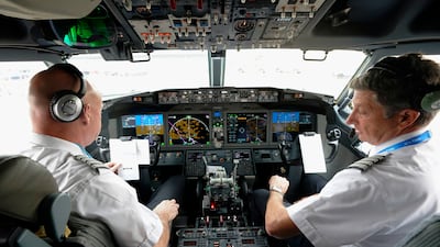 American Airlines pilots conduct a pre-flight check in the cockpit of a Boeing 737 Max jet before leaving Dallas. AP