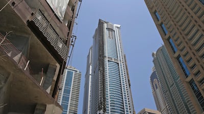 The Torch Tower, center, still bears the marks of fire damage caused by a blaze in 2015 and another earlier this month. Kamran Jebreili / AP Photo