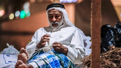 An Emirati fisherman demonstrates net-making. Victor Besa / The National