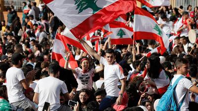 Student protesters wave their national flags as they protest against the government in front of the education ministry in Beirut. AP Photo