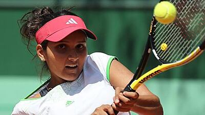 India's Sania Mirza hits a return in her 6-3, 6-3 first-round win against Germany's Kristina Barrois.
