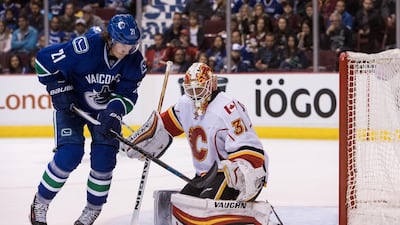 Loui Eriksson of the Vancouver Canucks is stopped by goaltender Chad Johnson of the Calgary Flames during the second period of their NHL game at Rogers Arena on October 15, 2016 in Vancouver, British Columbia, Canada. Ben Nelms / Getty Images