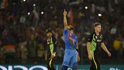 India’s Virat Kohli celebrates after victory in the World T20 cricket tournament match between India and Australia at The Punjab Cricket Stadium Association Stadium in Mohali on March 27, 2016. AFP / MONEY SHARMA