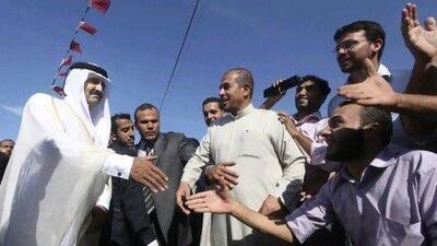 Qatar’s emir, Sheikh Hamad bin Khalifa Al Thani, is greeted by Palestinians at cornerstone laying ceremony for a new centre providing artificial limbs in the northern Gaza Strip.