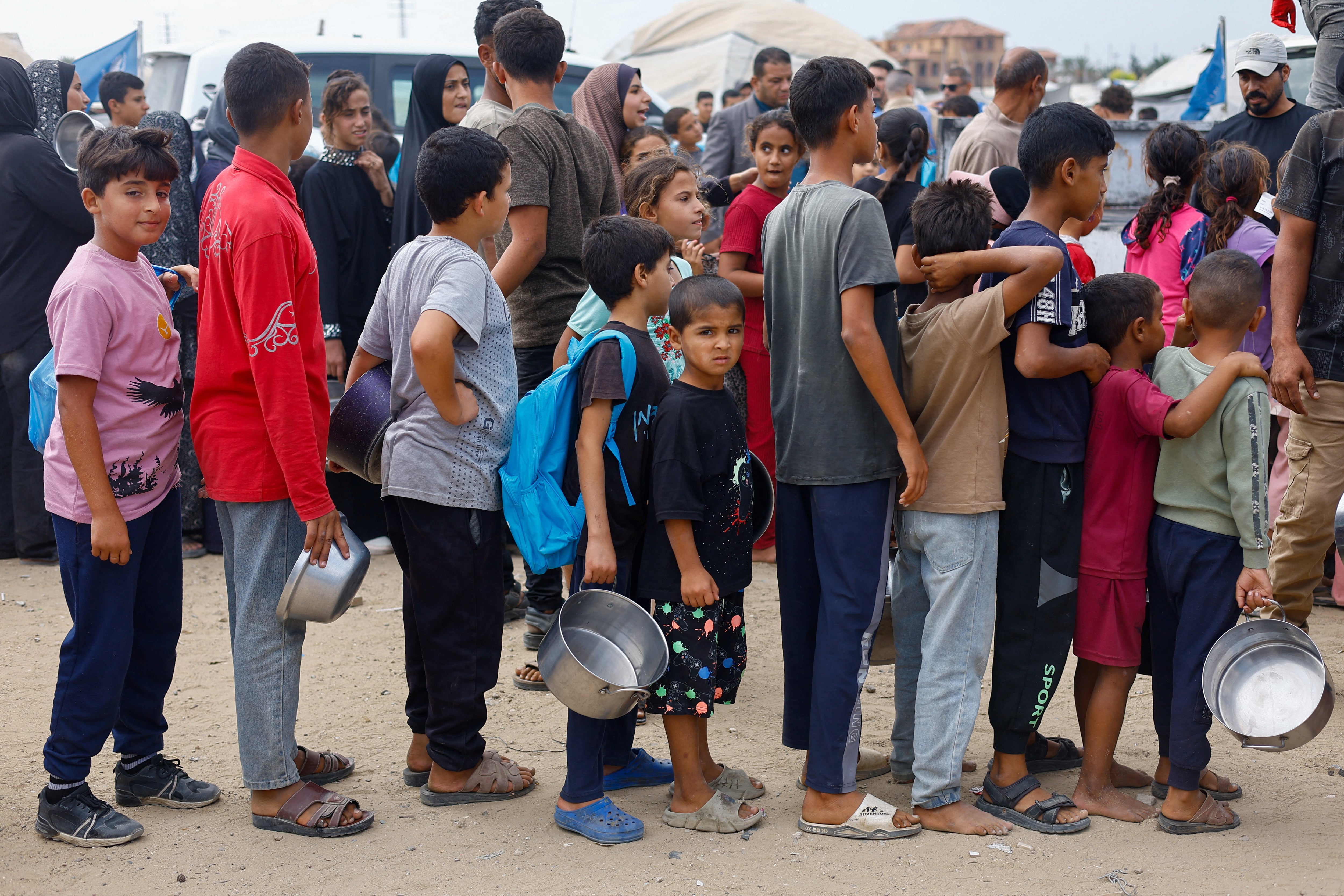 Children wait to receive food from a soup kitchen funded by the World Food Programme in Deir Al Balah, central Gaza. Reuters