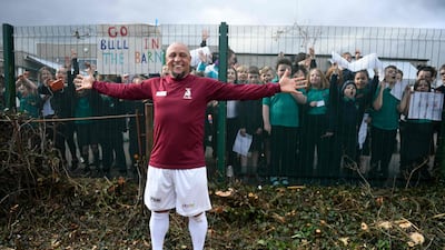 Roberto Carlos poses for photos after appearing in a match for Bull in the Barne United. AFP