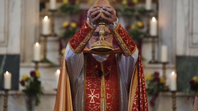 A clergy member attends Easter mass at the Armenian church in Baghdad. Reuters