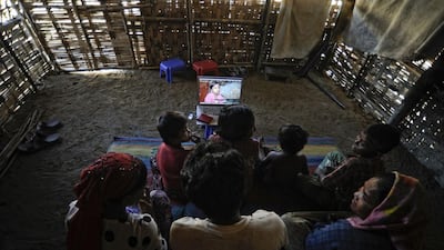 Members of Senwara Begum's family watch her video interview at the Ohn Taw refugee camp on the outskirts of Sittwe, Myanmar. AP Photo/Kaung Htet