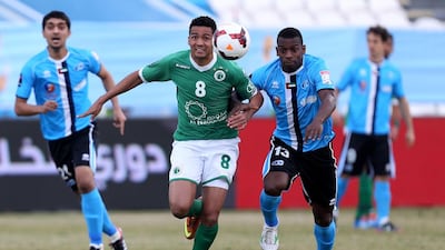 Al Shabab'sAdeilson, left, and Abdul Al Mukhaini clash for the ball. Sammy Dallal / The National