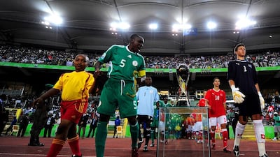 Nigeria's Fortune Chukwudi looks at the Fifa Under 17 World Cup trophy before the start of the finals match against Switzerland at the Abuja National Stadium on November 15, 2009, in Abuja, Nigeria. A former Nigerian international later claimed in a newspaper column that Chukwudi was 25 years old at the time. Jamie McDonald / Getty Images