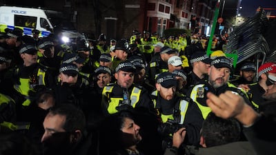 Police officers scuffle with Kurdish protesters after a raid by counter-terror police which led to six arrests. Getty Images