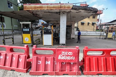 Armed Sri Lankan military personnel stand guard at a closed gas station amid a fuel shortage in Colombo, Sri Lanka. Photo: EPA