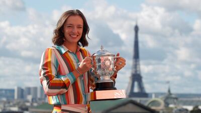 Iga Swiatek poses with the trophy. Reuters