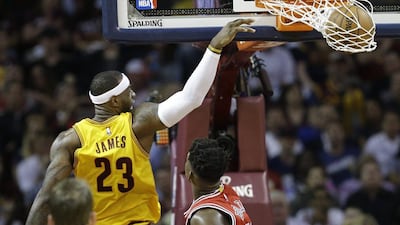 LeBron James of the Cleveland Cavaliers dunks over Jimmy Butler of the Chicago Bulls on Wednesday in Game 2 of their NBA play-offs second round series. Tony Dejak / AP / May 6, 2015