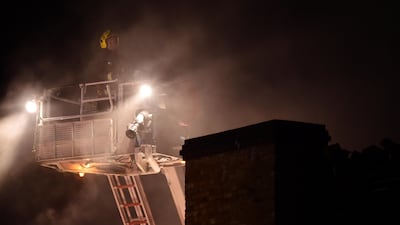 A firefighter tackles a fire at Camden Market in north London, Britain, July 10, 2017. REUTERS/Hannah McKay