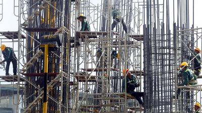 Labourers work at the construction site of an apartment building in Hanoi. Successful property transactions in Vietnam have doubled from a year ago. Kham / Reuters