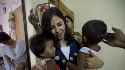 Maria Conceicao, an Emirates airline stewardess who founded The Dhaka Project, holds two children in a shelter in Dhaka.