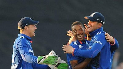 England's Chris Jordan, second right, is congratulated by Jos Butler, left, and Alex Hales after bowling New Zealand's Mitchell McClenaghan caught Alex Hales for 2 runs during their ODI match at Edgbaston cricket ground in Birmingham, England, Tuesday, June 9, 2015. (AP Photo/Rui Vieira)