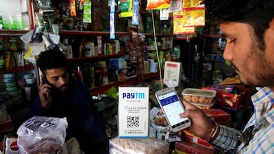 An Indian shopkeeper receives payment by Paytm mobile phone technology a at stationery shop in Bhopal. Paytm launched a mini-store to rival Google's app store. EPA