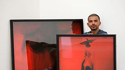 Syrian artist Jaber Al Azmeh with his work at the Green Art Gallery in Alserkal Avenue in Dubai. Pawan Singh / The National