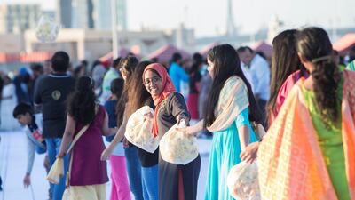 Volunteers arranging flowers to be laid in an attempt to create the world's largest fresh flower carpet with the theme of Tolerance to highlight the UAE as a global capital for tolerance at Dubai Festival City. Leslie Pableo for The National