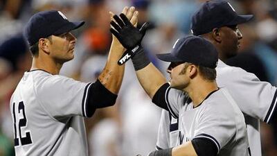 New York Yankees' Eric Chavez and Nick Swisher celebrate their win against the New York Mets.