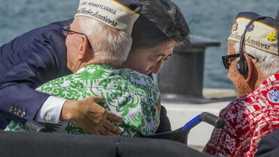 Japanese Prime Minister Shinzo Abe embraces a World War II Pearl Harbor survivor after he and US President Barack Obama spoke on Kilo Pier, overlooking the USS Arizona Memorial, at Joint Base Pearl Harbor-Hickam, Hawaii, Tuesday, Dec. 27, 2016. (Dennis Oda/The Star-Advertiser via AP, Pool)