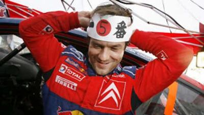 Sebastien Loeb of the Citroen team celebrates after claiming his fifth WRC title with a third place finish at the Rally of Japan.