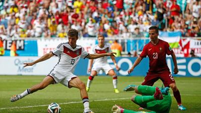 Thomas Muller of Germany shoots and scores his team's fourth goal and completes his hat trick past Rui Patricio of Portugal during their 2014 World Cup Group G match on Monday in Salvador, Brazil. Phil Walter / Getty Images