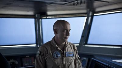 Rear Admiral Roy Kelley, the commander of carrier strike group 12, stands inside the flag bridge on board the USS Theodore Roosevelt.