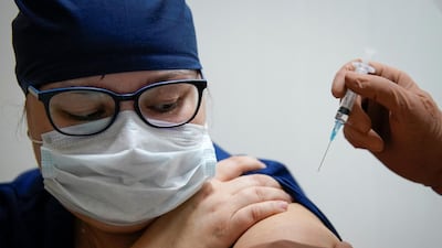 A medic receives Russia's Sputnik V vaccine shot against the coronavirus. Reuters
