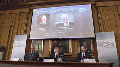 From left: Tomas Sjoestroem, a member of the Nobel Economics Prize committee; Goran K Hansson, the secretary general of the Royal Swedish Academy of Sciences; and Per Stroemberg, the chairman of the Nobel Economics Prize committee, during the announcement of this year’s winners. Jonathan Nackstrand / AFP