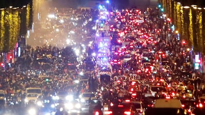 PSG fans celebrate in front of the Arc de Triomphe. Reuters