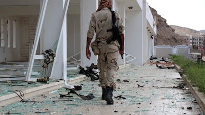 A fighter from the Southern Transitional Council walks at the site of two suicide car bombings that targeted the headquarters of an anti-terror unit the day before in the southern Yemeni port of Aden. AFP