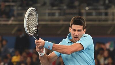 Novak Djokovic plays a shot during his match against Roger Federer at the International Premier Tennis League match in New Delhi on Monday. Sajjad Hussain / AFP / December 8, 2014