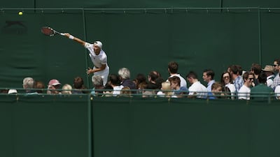 Spectators watch play on an outside court on Day 3 of the 2014 Wimbledon Championships on Wednesday. Stefan Wermuth / Reuters