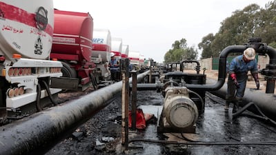 The unloading of oil from lorries arriving from Iraq at the Baniyas oil terminal in Syria. Reuters