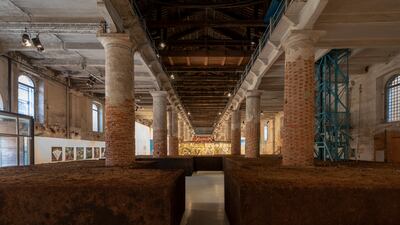 Delcy Morelos' 'Earthly Paradise, 2022', fills the cavernous Arsenale with packed, redolent earth. Photo: Roberto Marossi