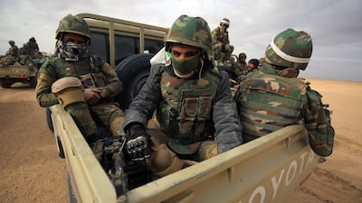 Iraqi forces ride in the back of pick-up trucks during the advance through Anbar province in the western desert bordering Syria, on November 25, 2017, to flush out remaining ISIS fighters in the region.