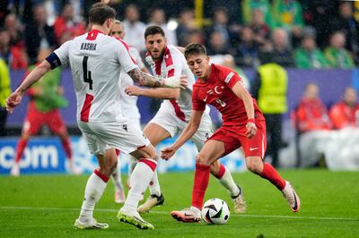 Turkey’s Arda Guler in action against Georgia's Guram Kashia. PA