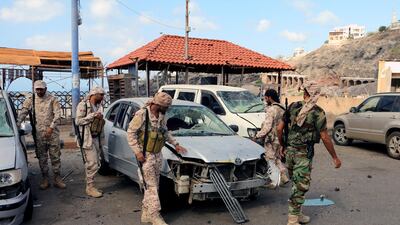 Yemeni soldiers inspect the site of car bomb attacks that struck the entrance of a military base and a checkpoint near the headquarters of the secessionist Southern Transitional Council, in the southern port city of Aden, on February 25, 2018. EPA