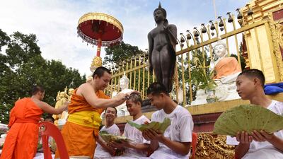 Monks cut the hair of the rescued boys and their coach. AFP