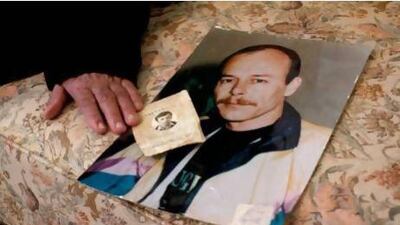 Widad Younis at home at Israel with a photograph of her imprisoned son Maher that was taken four years ago with his high school ID document from 1980.