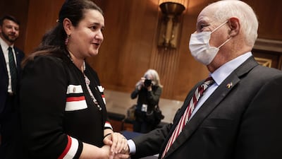Ukraine's ambassador to the US, Oksana Markarova, greets Mr Cardin before a hearing with the Helsinki Commission in March 2022 in Washington. Getty / AFP