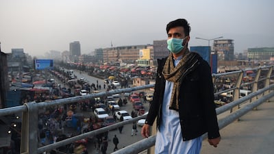 An Afghan resident walks along an overpass amid heavy smog conditions in Kabul. AFP