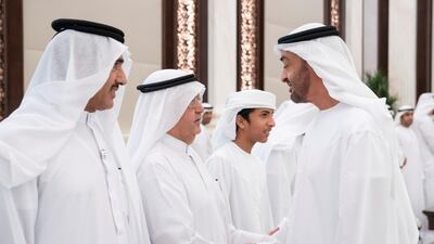 Sheikh Mohamed bin Zayed (right), greets Hamad Abdul Rahman Al Madfa, Secretary General of the Supreme Council of the Union Affairs in the Ministry of Presidential Affairs (second left), during an iftar reception, at Abu Dhabi's Al Bateen Palace. Seen with Ahmed Juma Al Zaabi, UAE Deputy Minister of Presidential Affairs (left).