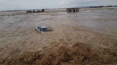 A car almost submerged beneath raging floodwaters in Fkirina, Oum El Bouaghi province, north-east Algeria. Photo: Algeria Civil Defence