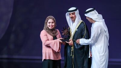 The Outstandinfg Nanny Award is given to Rosemarie Salmorine from the Philippines by Sheikh Hazza bin Zayed bin Sultan. Victor Besa / The National