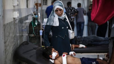 An injured Palestinian boy in hospital after the strike on Nuseirat refugee camp in Gaza. AFP