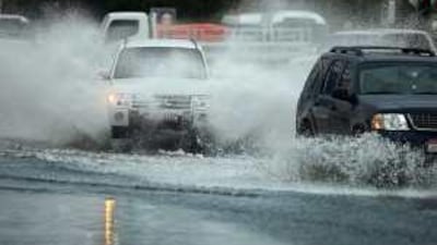 Traffic navigates flood waters on 15th street in Abu Dhabi after heavy rains.
